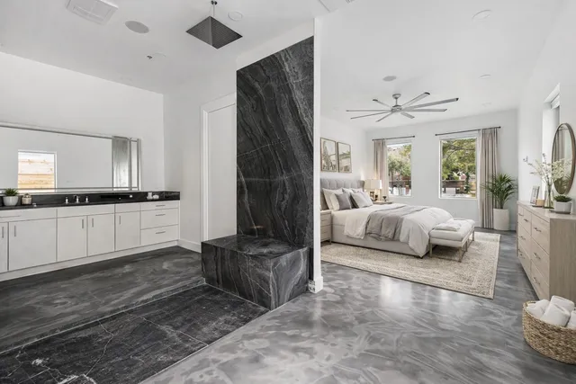 a bedroom with furniture and a large window