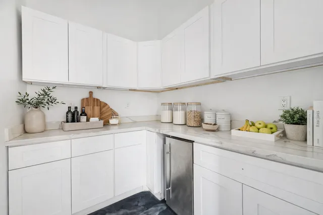 a kitchen with white cabinets and a sink