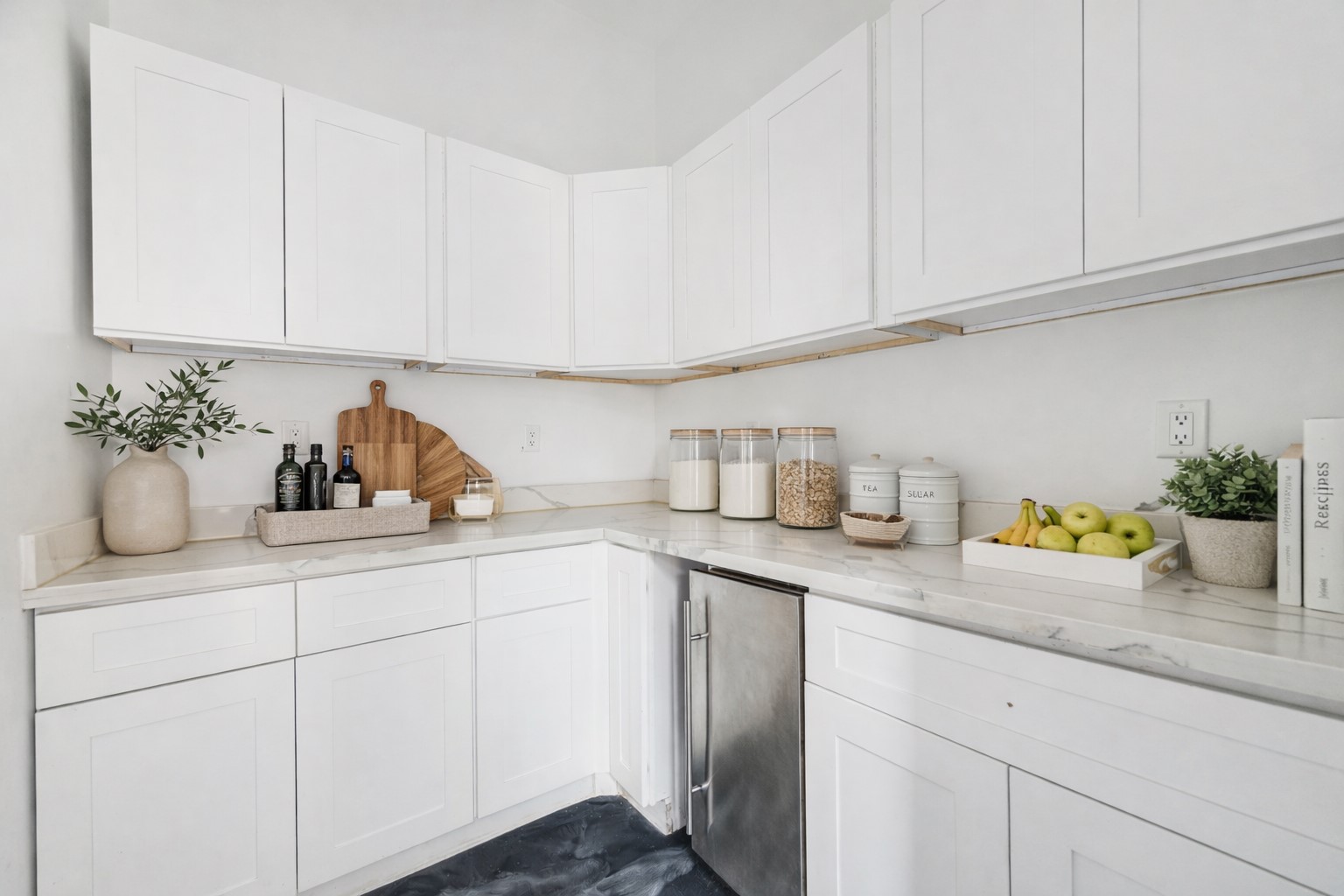 3735 University Boulevard Houston, TX 77005 - Photo 14 of 18 a kitchen with white cabinets and a sink