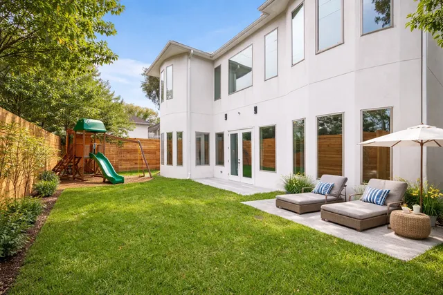 a view of a house with backyard sitting area and garden