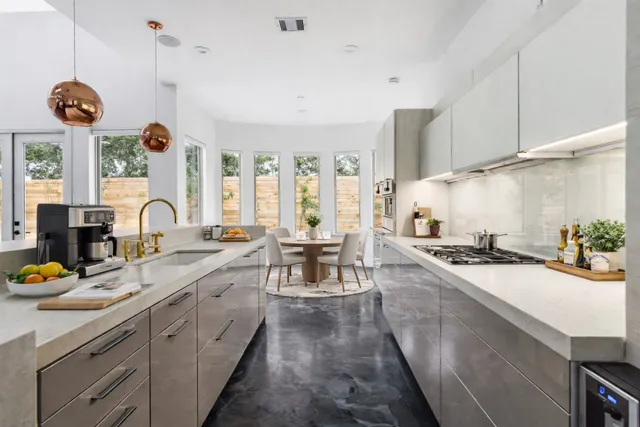 a kitchen with sink stove and cabinets