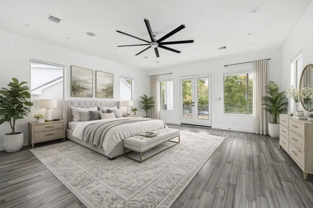 a spacious bedroom with a large bed and windows