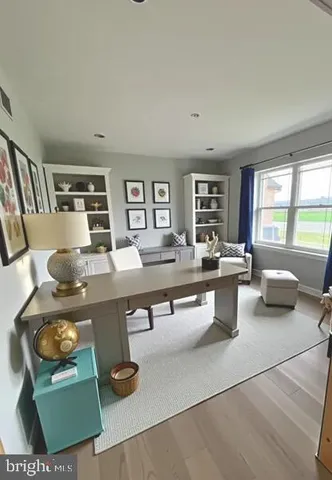 a living room with furniture a rug and a large window