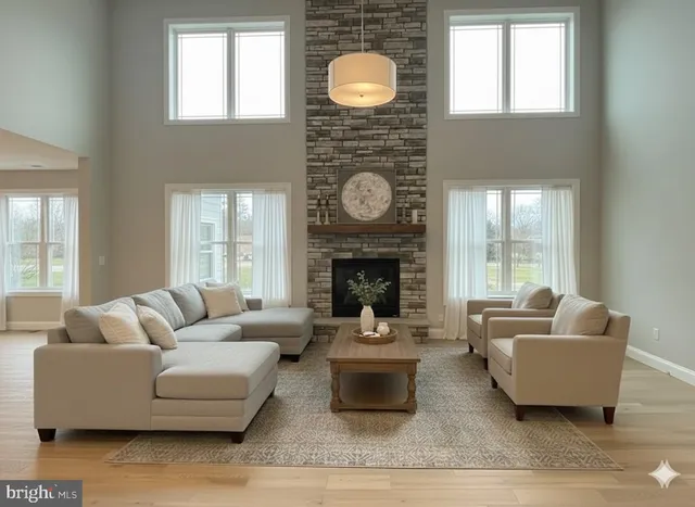 a living room with furniture a fireplace and window