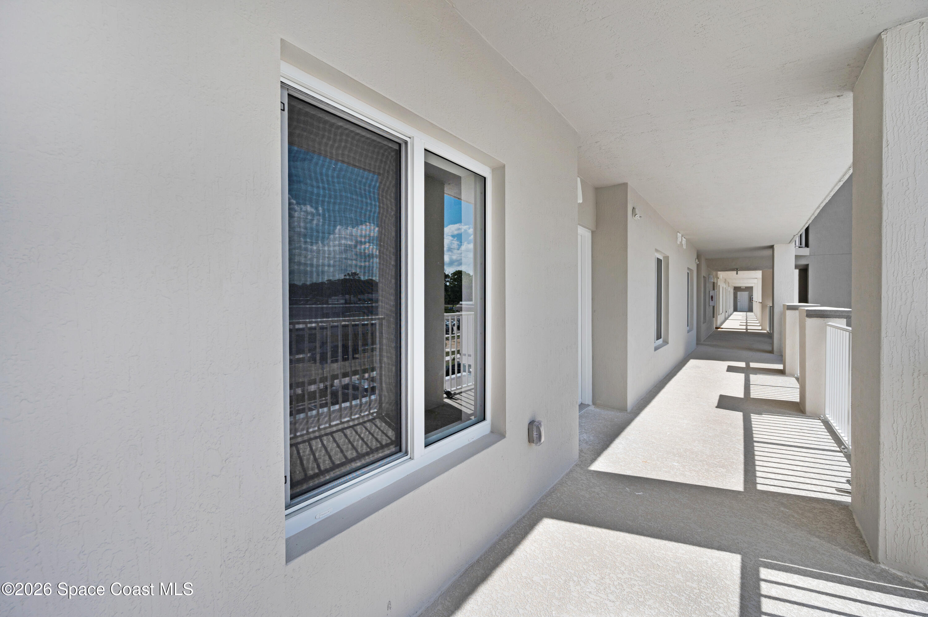 1805 Riverside Drive, Unit 304 Titusville, FL 32780 - Photo 13 of 46 a view of a hallway with wooden floor and entryway