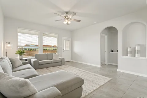 a living room with furniture and a large window