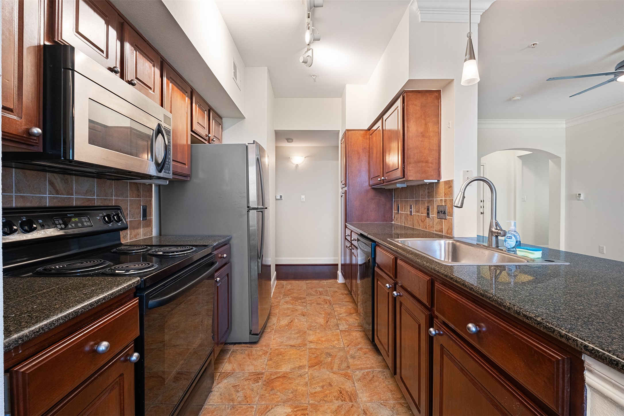 7701 Rialto Boulevard, Unit 637 Austin, TX 78735 - Photo 11 of 25 A well-equipped kitchen features durable tile flooring, ample cabinetry, and sleek stainless steel appliances.