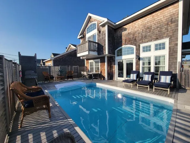 a swimming pool view with a outdoor seating