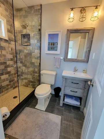 a bathroom with a toilet sink and shower