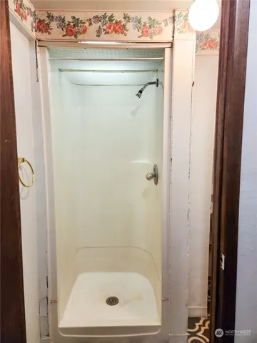 a bathroom with a toilet and a shower curtain