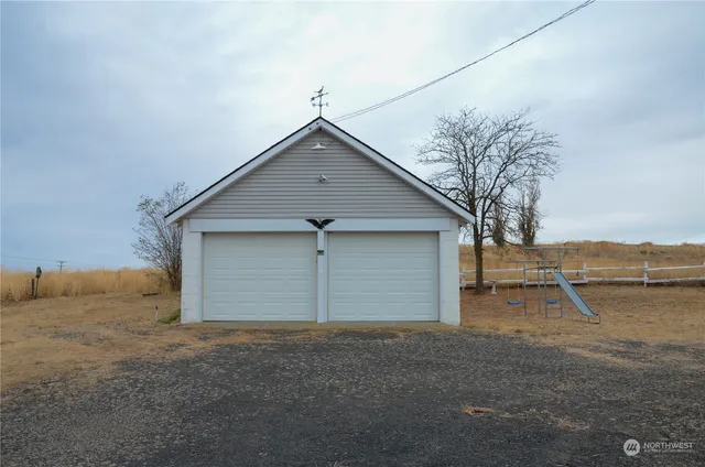 a view of a house with a bed and wooden fence