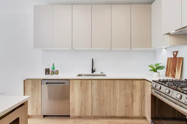 a kitchen with white cabinets and white appliances