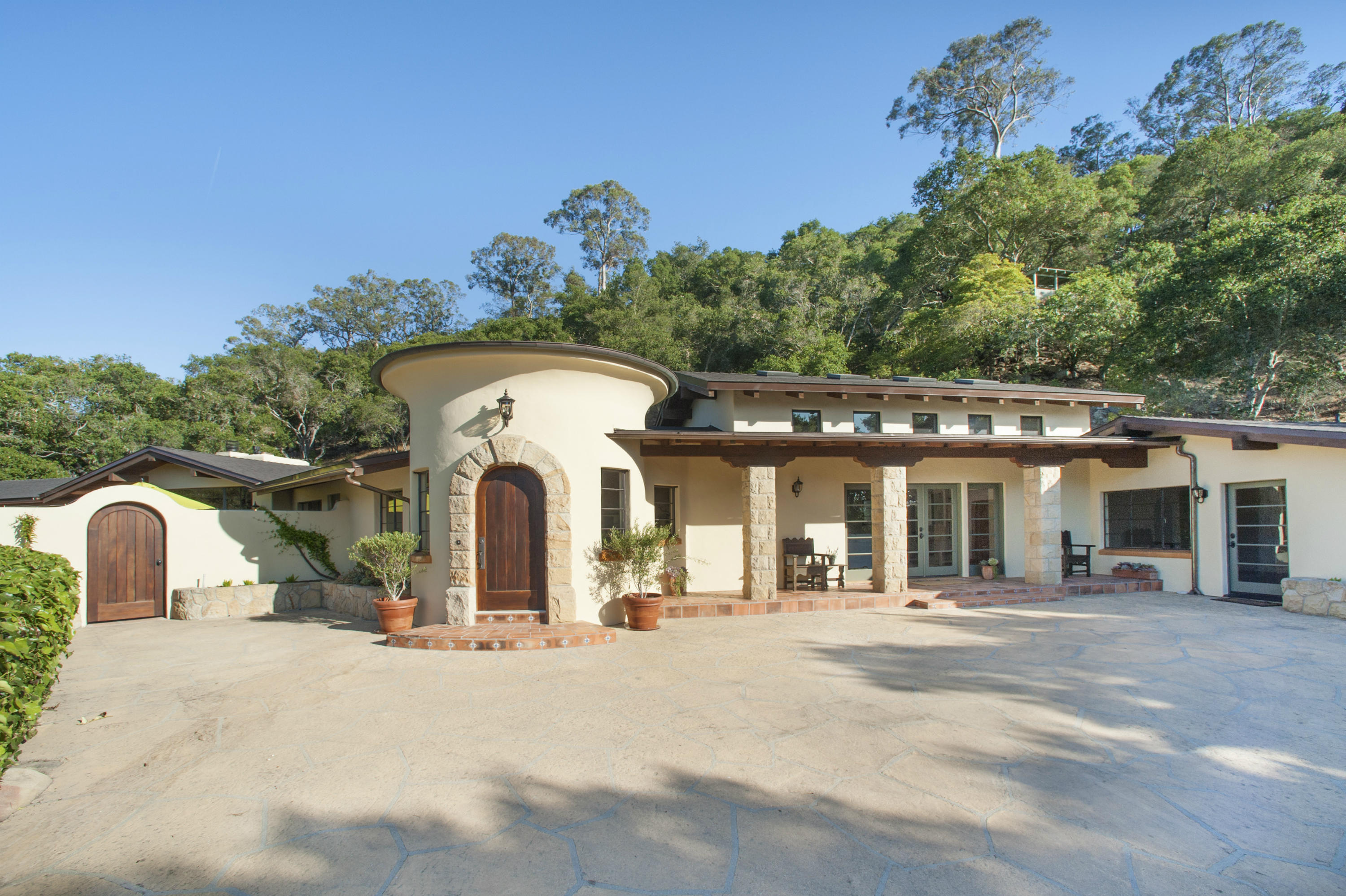 a front view of a house with a garden