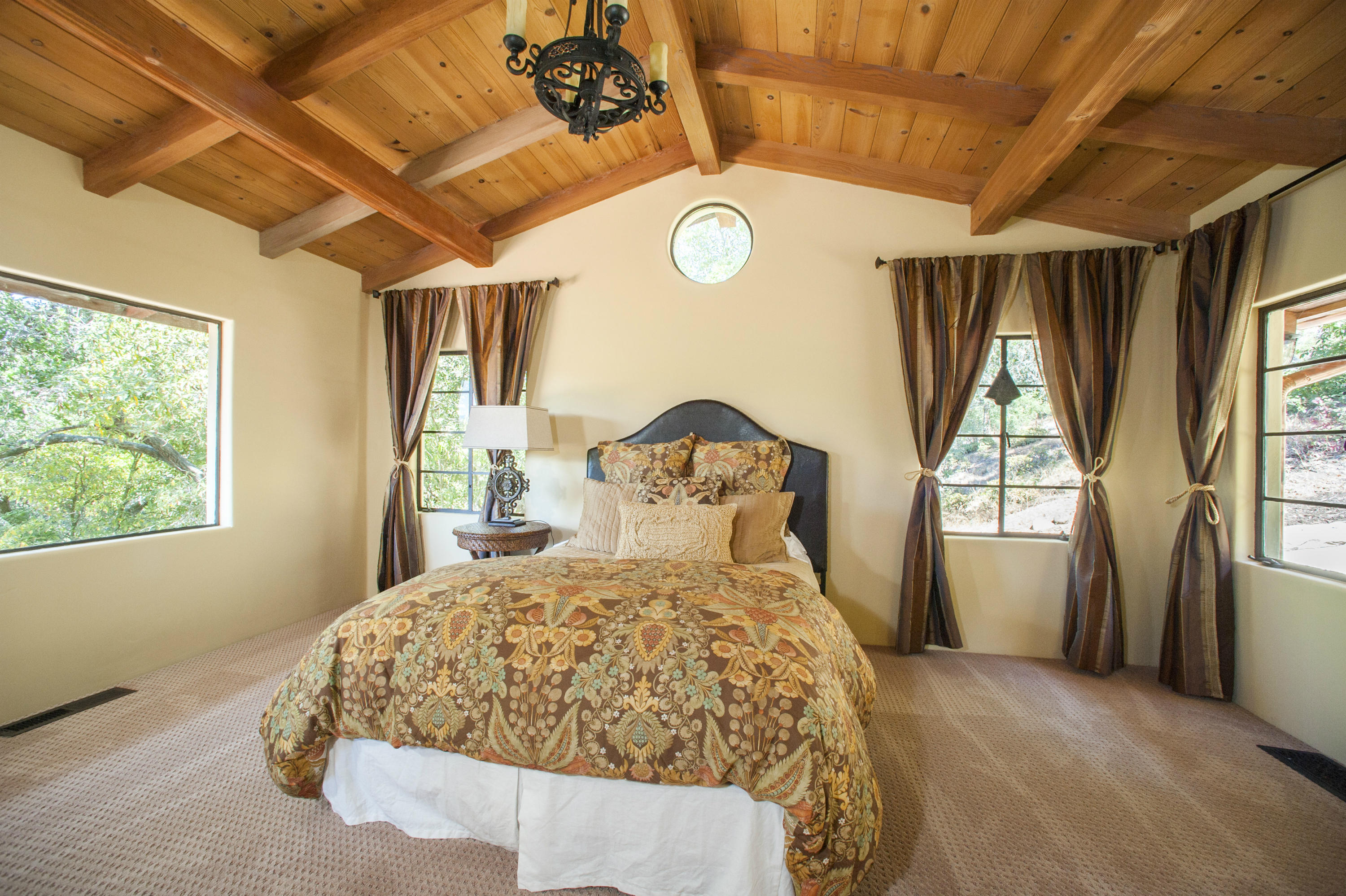 398 Mountain Drive Santa Barbara, CA 93103 - Photo 13 of 28 a bed sitting in a spacious bedroom next to a window