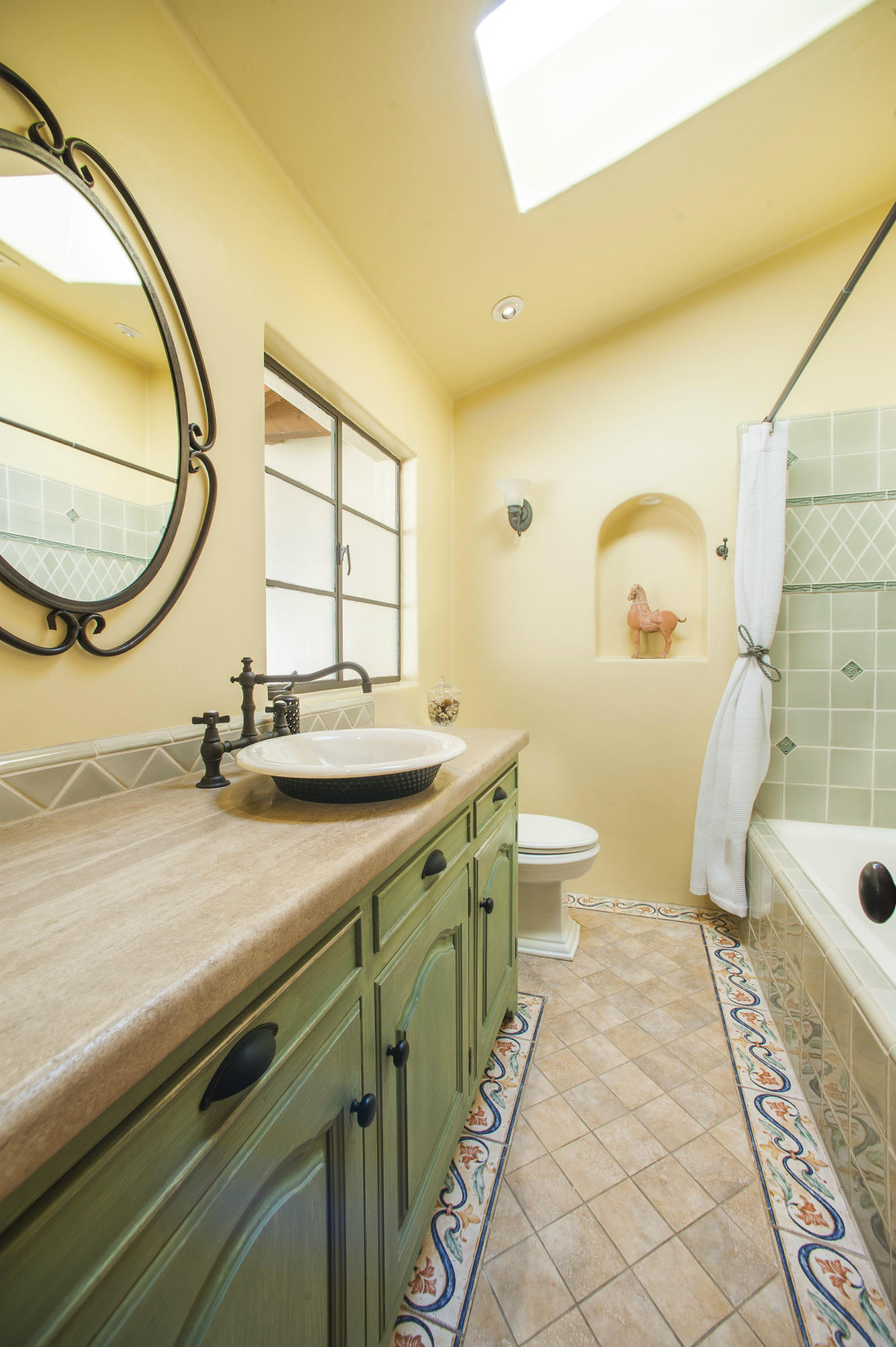 398 Mountain Drive Santa Barbara, CA 93103 - Photo 14 of 28 a bathroom with a sink a toilet and a mirror