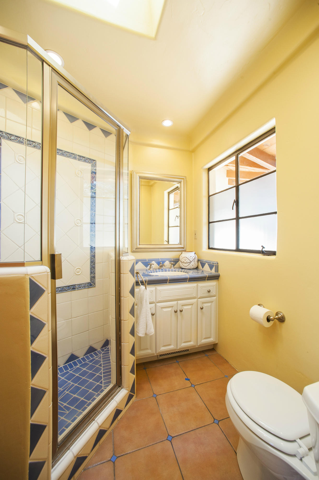398 Mountain Drive Santa Barbara, CA 93103 - Photo 15 of 28 a bathroom with a granite countertop sink toilet and shower