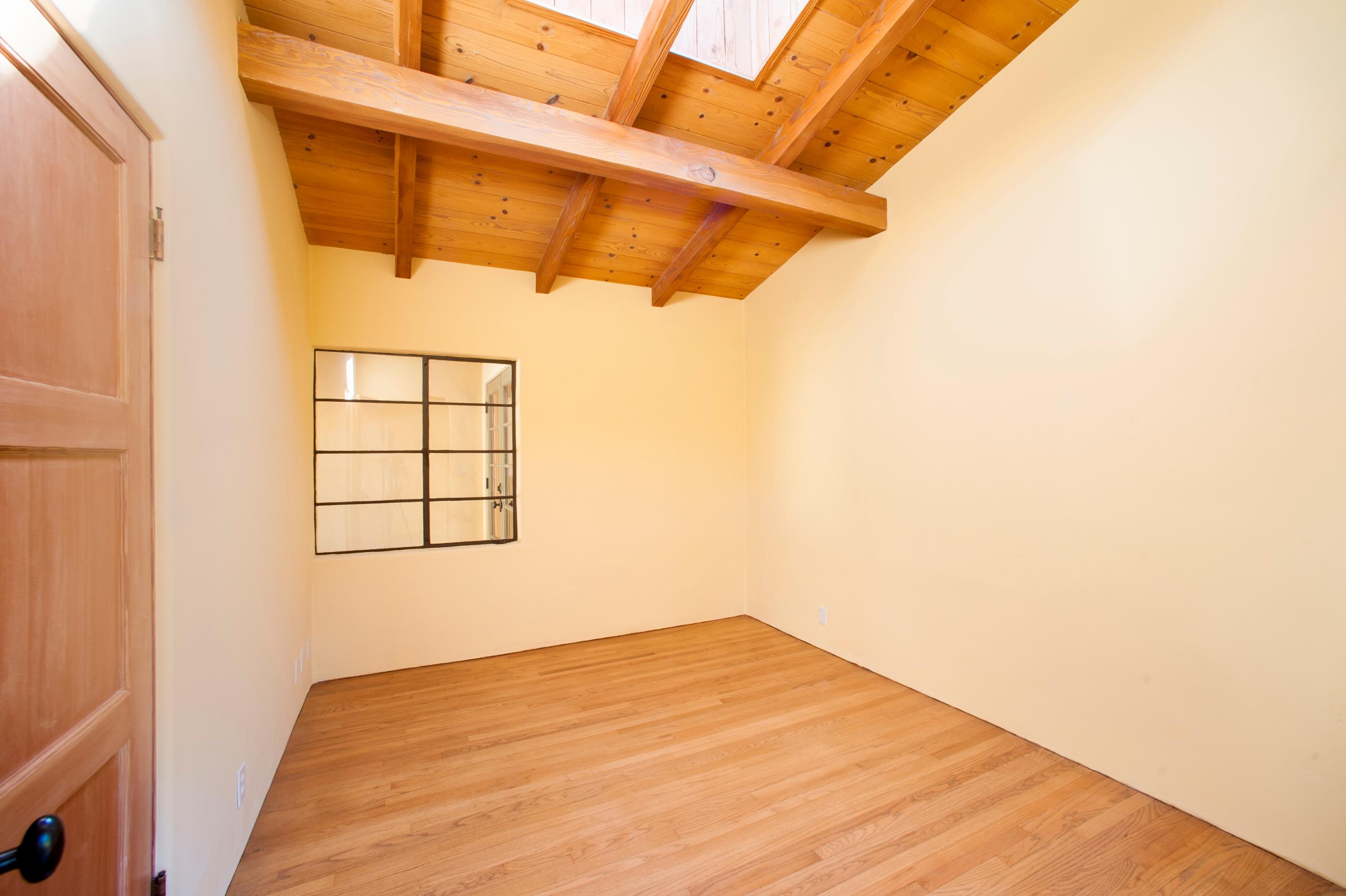 398 Mountain Drive Santa Barbara, CA 93103 - Photo 16 of 28 a view of a room with wooden floor and windows