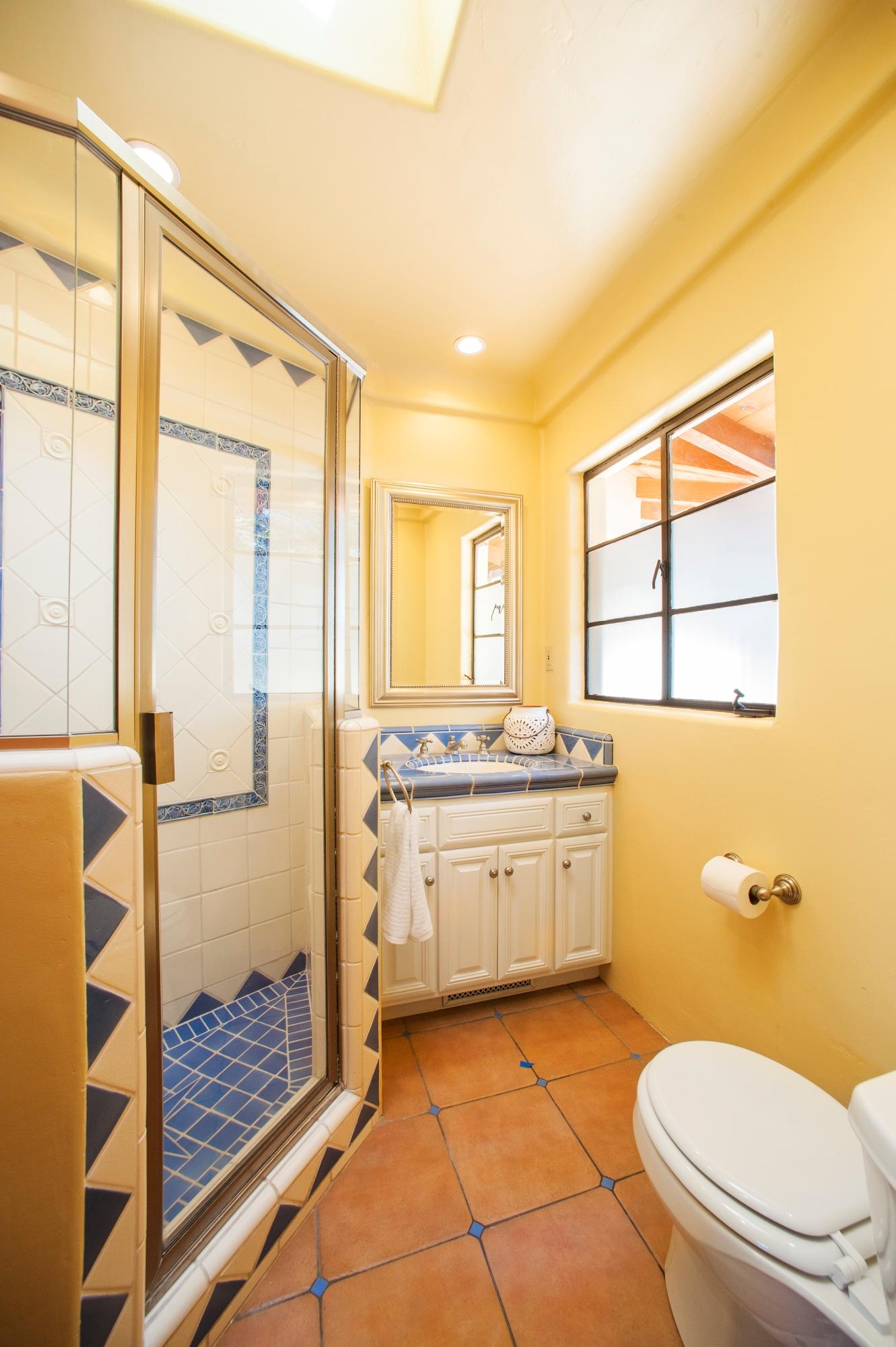398 Mountain Drive Santa Barbara, CA 93103 - Photo 20 of 28 a bathroom with a granite countertop sink toilet and shower