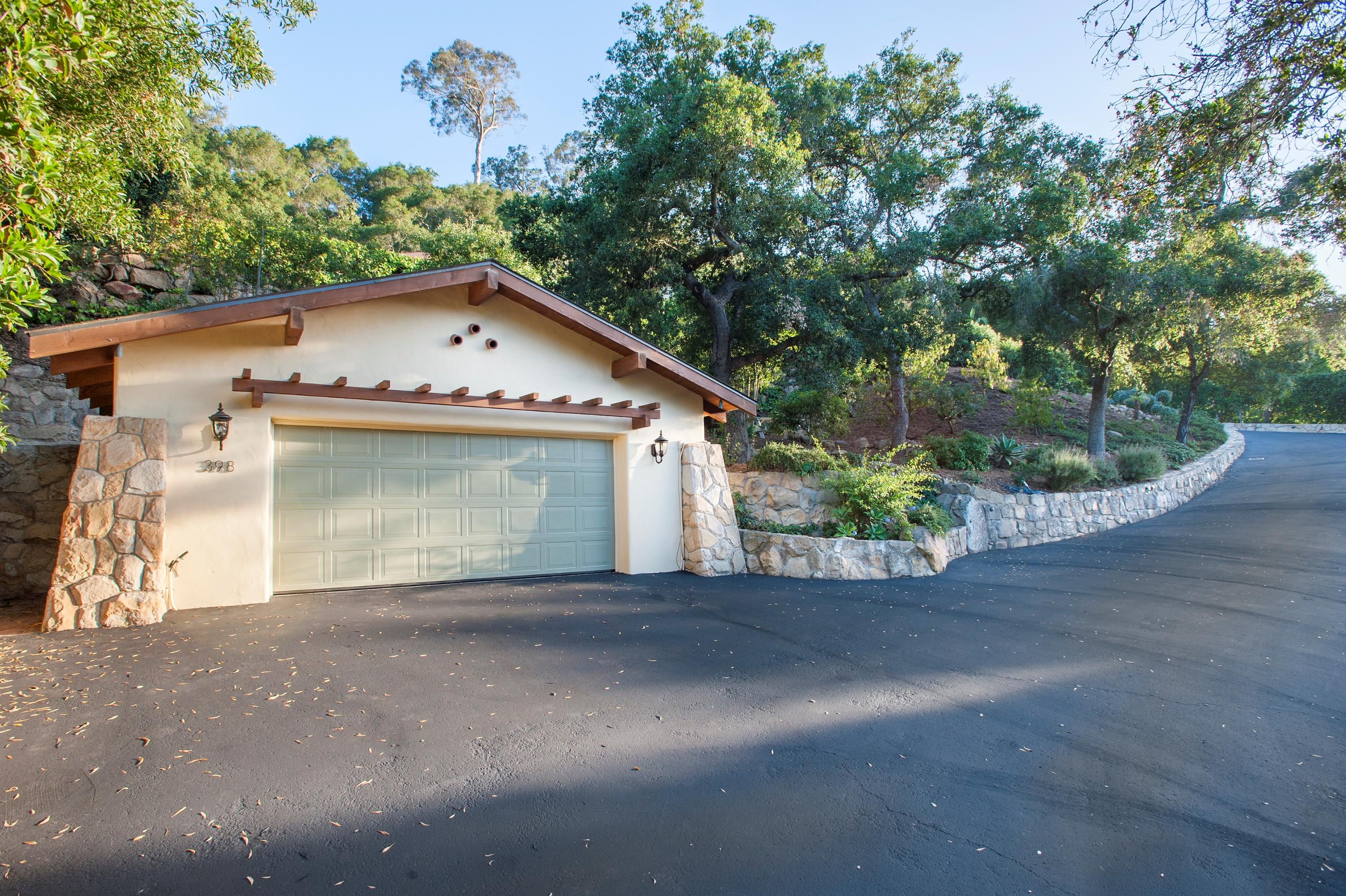 398 Mountain Drive Santa Barbara, CA 93103 - Photo 28 of 28 a front view of a house with a yard and garage