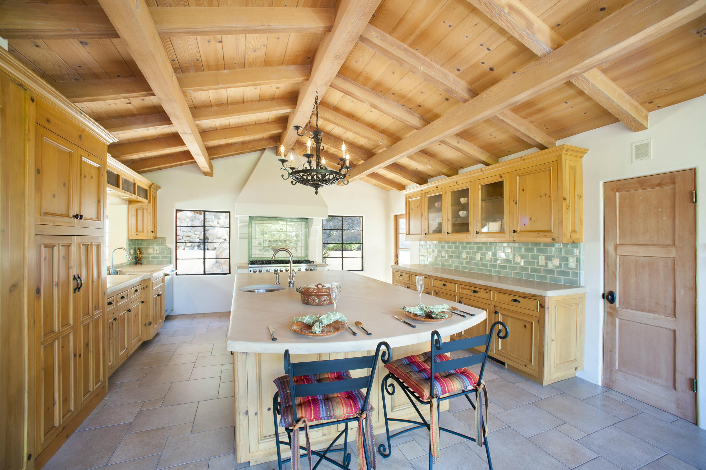 398 Mountain Drive Santa Barbara, CA 93103 - Photo 6 of 28 a dining room with furniture a kitchen a chandelier and wooden floor