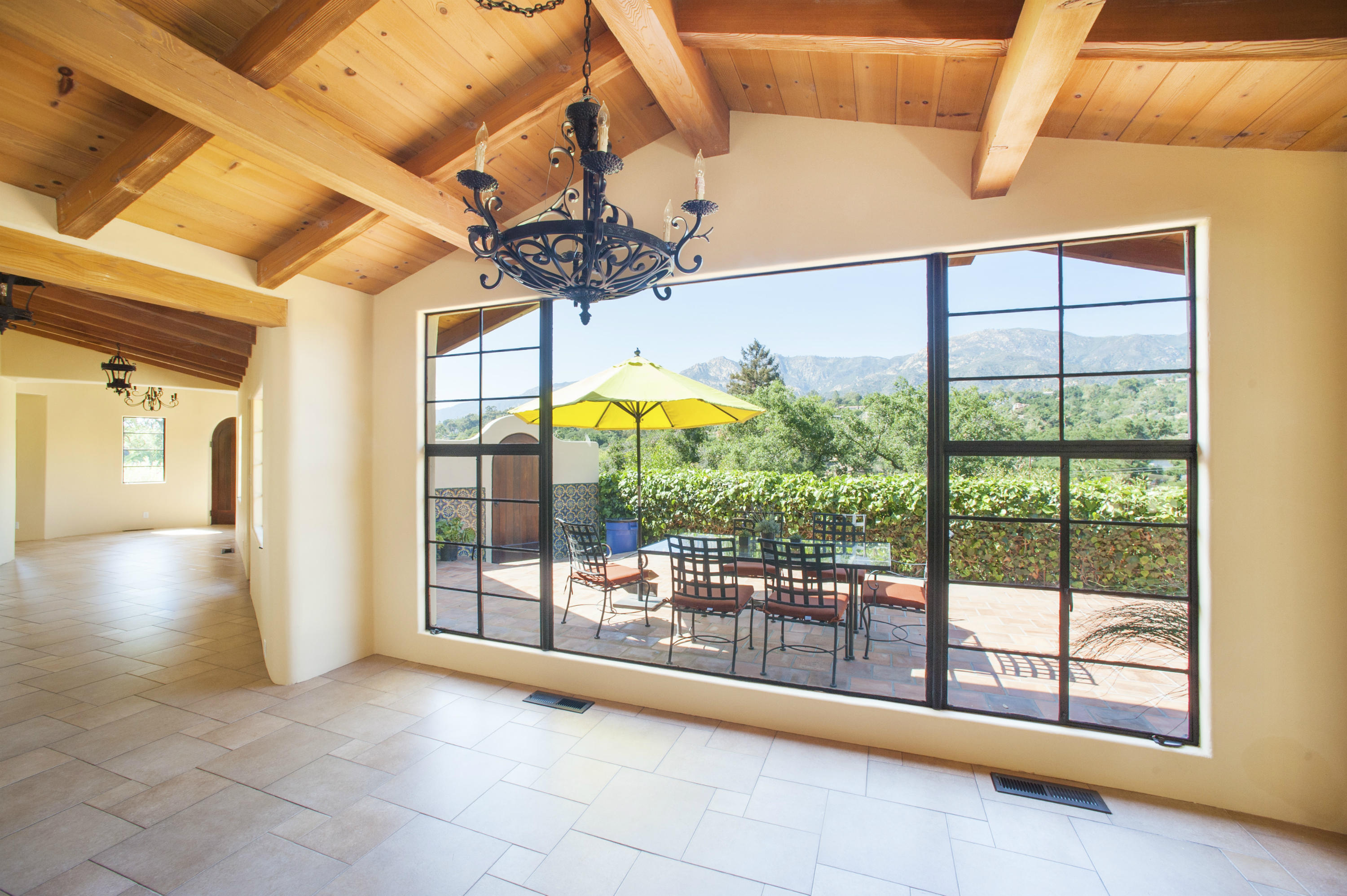 398 Mountain Drive Santa Barbara, CA 93103 - Photo 8 of 28 a view of an entryway with a floor to ceiling window and a table