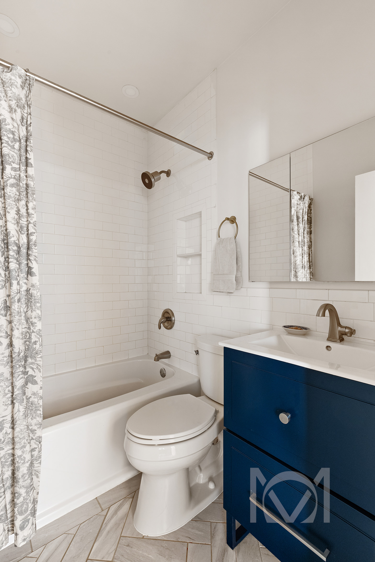 132 Remsen Street, Unit 12 Brooklyn, NY 11201 - Photo 4 of 8 a bathroom with a toilet a sink a mirror a bathtub and vanity