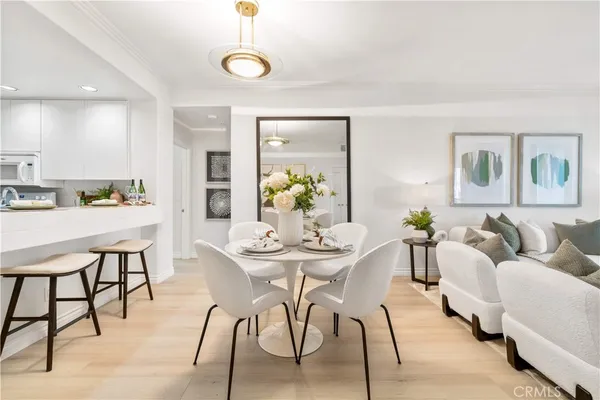 a living room with furniture kitchen and a chandelier