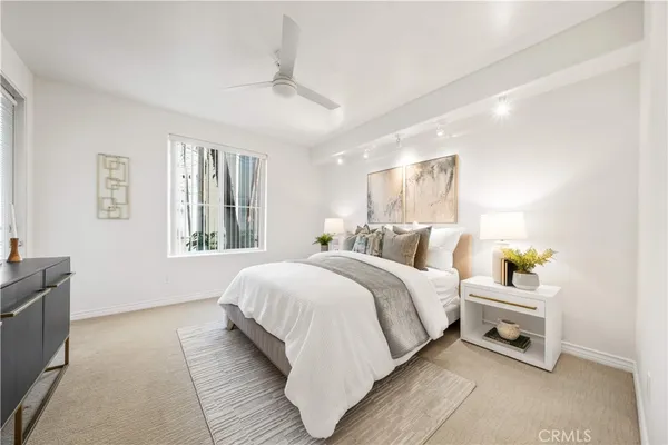 a bedroom with bed and a window