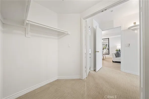 a view of a room with a furniture and a ceiling fan