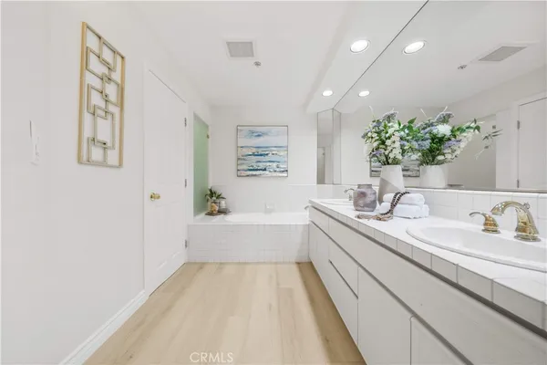 a bathroom with a bathtub sink and mirror