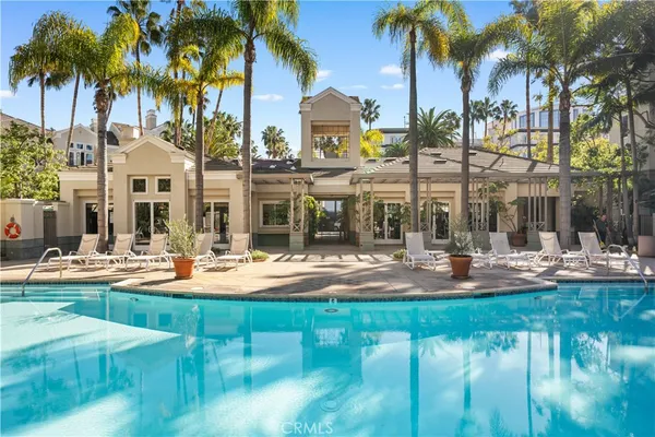 a view of a house with swimming pool and sitting area