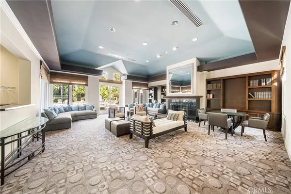 a living room with fireplace furniture and a large window