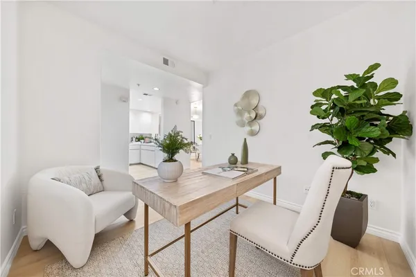 a workspace with furniture and a potted plant