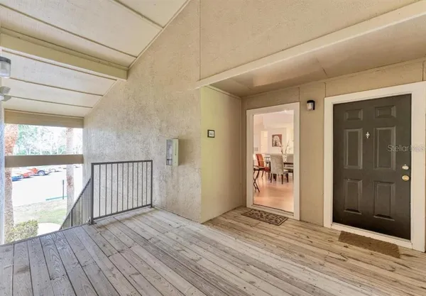 a view of a hallway with wooden floor and a window