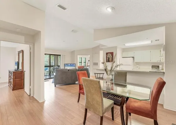 a dining room with furniture and wooden floor