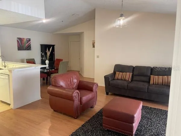 a living room with furniture a couch and a bookshelf