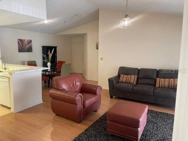 a living room with furniture a couch and a bookshelf