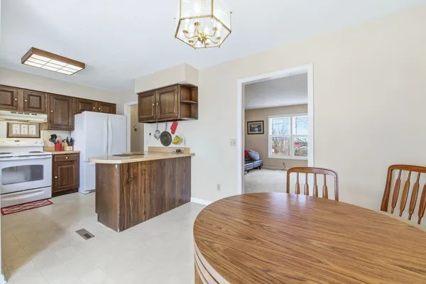 a dining room with furniture and large windows