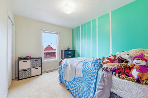 a bedroom with a bed and a book shelf