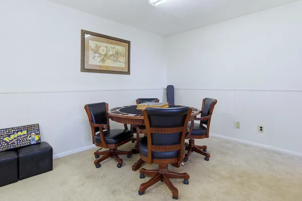 a bedroom with a bed a book shelf and a shelf
