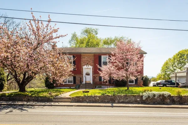 a view of a house with a balcony and wooden floor