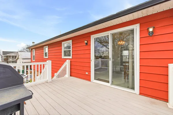 a view of a house with a balcony and wooden floor