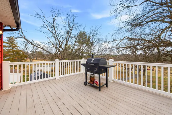 a view of a deck with furniture and wooden floor