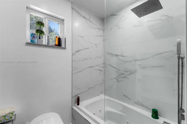 a bathroom with a bathtub and a shower