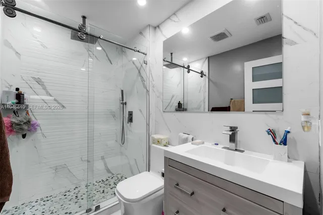 a bathroom with a sink toilet and shower