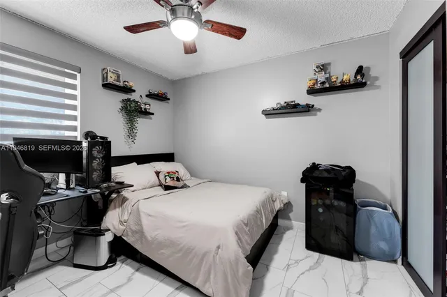 a bedroom with a bed and a chair