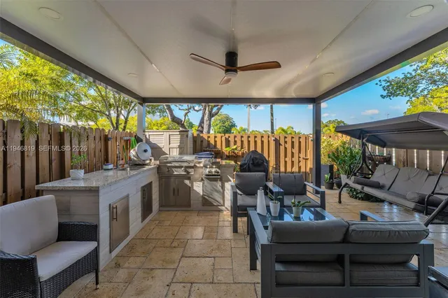 a living room with patio furniture and a large window