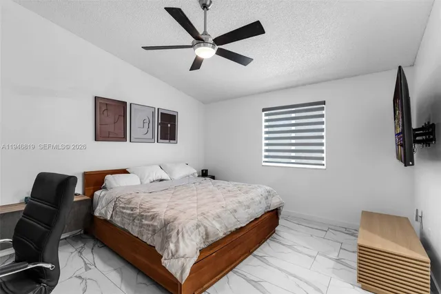 a bedroom with a bed and a chair