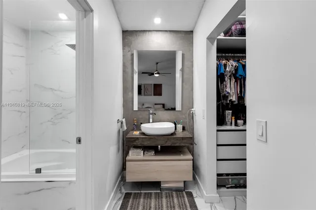 a bathroom with a sink a toilet and shower