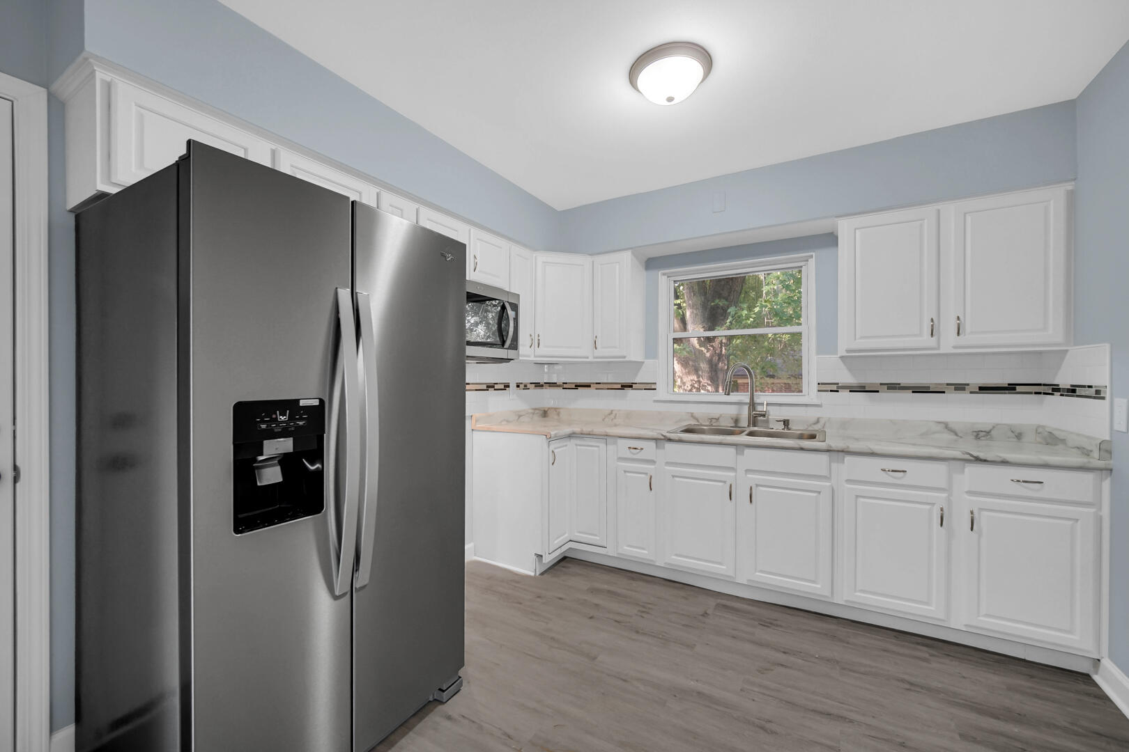 3816 Lincoln Street Gary, IN 46408 - Photo 7 of 21 a kitchen with stainless steel appliances granite countertop a refrigerator and a sink